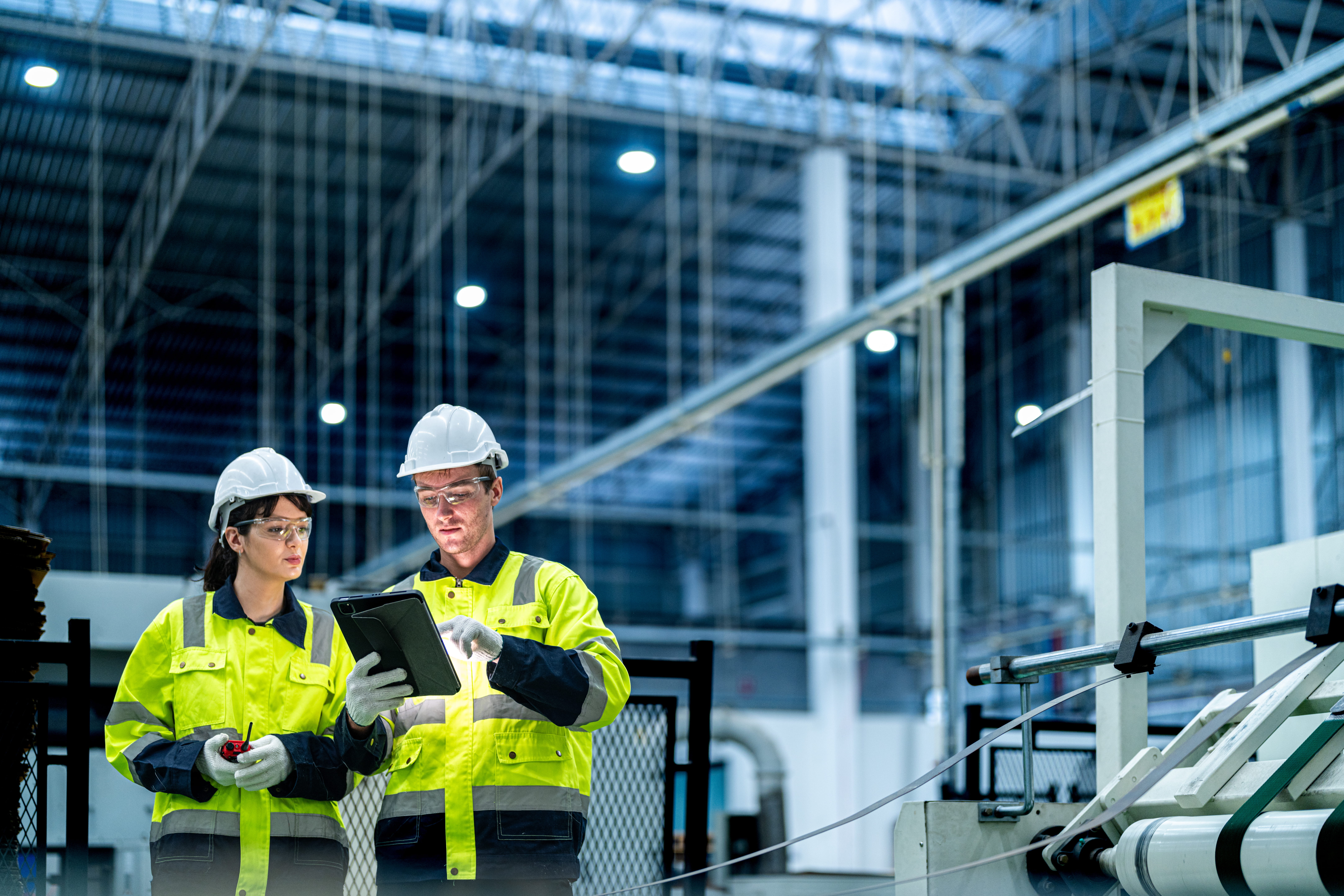 Electrical professionals reviewing equipment in an industrial facility
