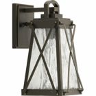 A cottage-inspired outdoor small wall lantern with a tapered cage. Creighton features clear water glass clear and Antique Bronze finish. The frame's linear details are riveted to enhance mechanical detailing of the fixture. Wall, post and hanging lantern options available. Antique Bronze finish.