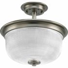 The Archie Collection brings a vintage, industrial flair to interior settings. The collection?s distinctive double prismatic glass adds visual interest as its crisscross pattern comes to life when illuminated. This two-light semi flush can be mounted to ceiling or chain mounted for a variety of locations. Antique Nickel finish.