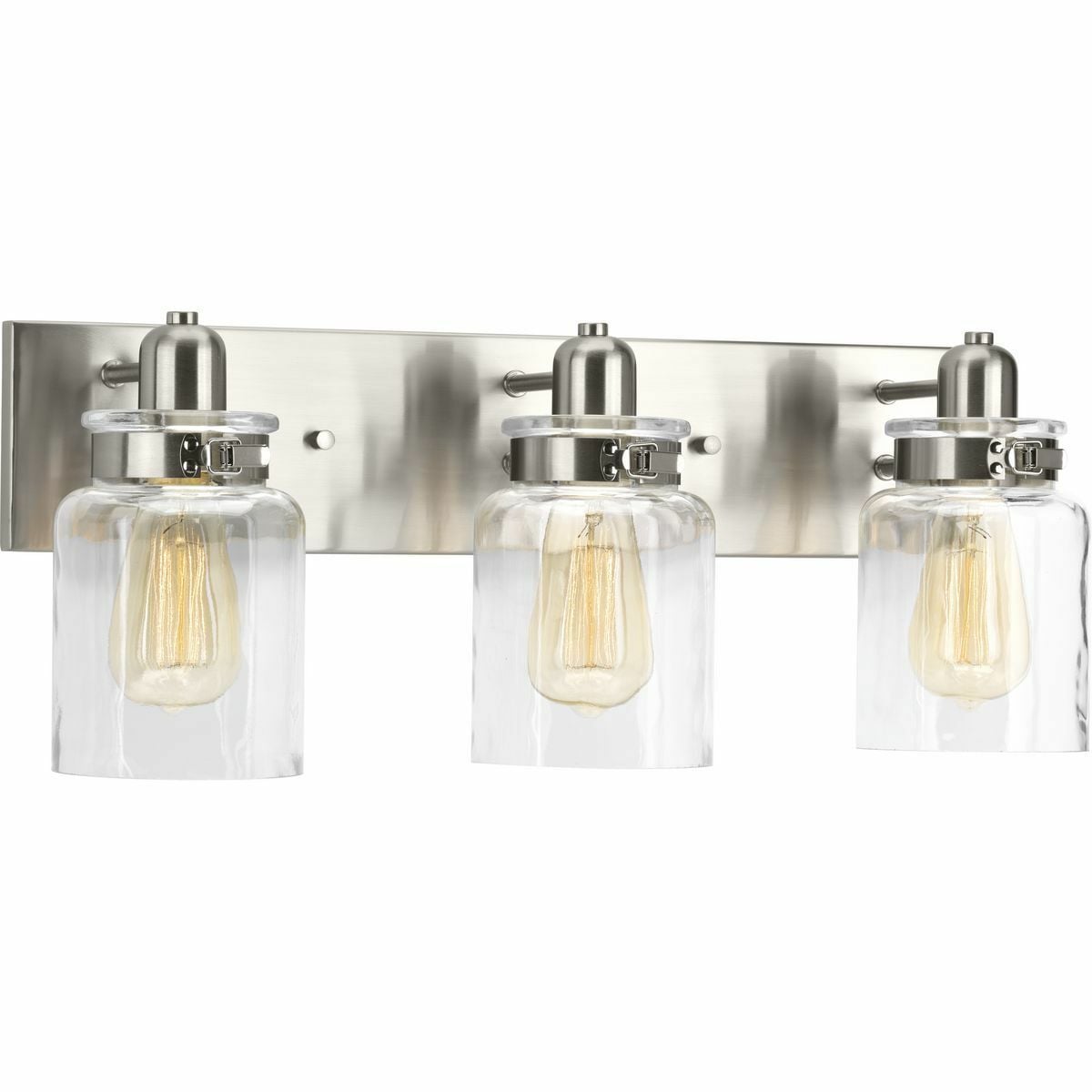 A delightful trend in home decor is the repurposing of antique parts into new, functional furniture and accessories. The Calhoun Collection playfully follows this lead with an apothecary style and features a clear glass diffuser held in place with a mechanical latch from a spice container. The glass shade showcases a thickened profile to create a vintage-style surface for a classic handmade appearance. Three-Light bath & vanity with a Brushed Nickel finish.
