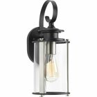 Squire one light small wall lantern features a classic traditional profile with clean, modern metal fittings. The Black finish is accented with contrasting Stainless Steel metallic elements, the cylindrical frame is comprised of a clear glass diffuser.
