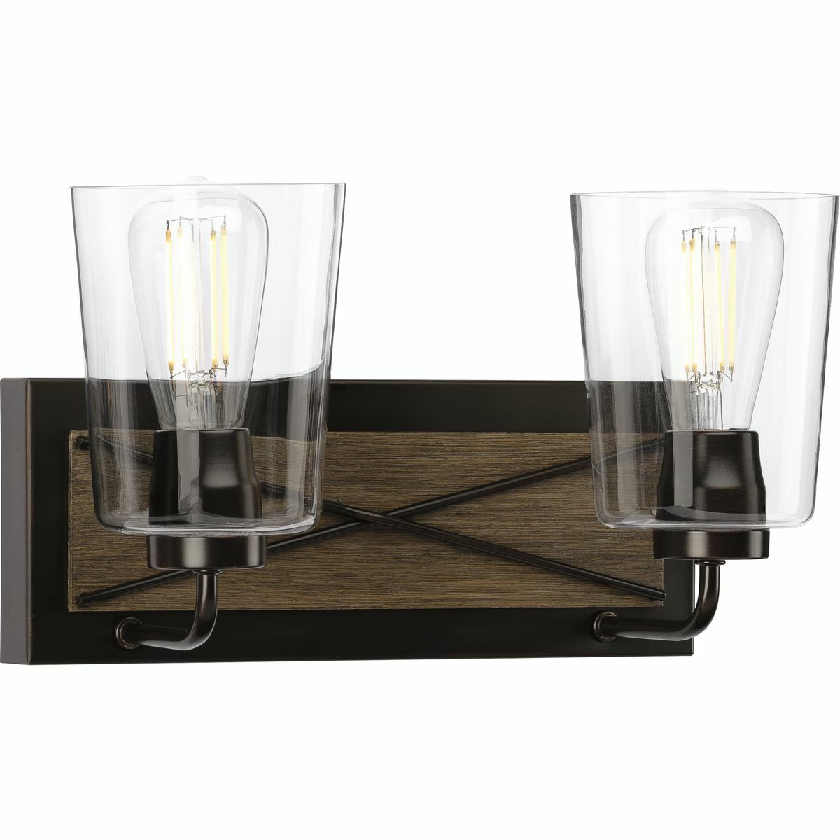 Incorporate farmhouse-inspired d?cor above a bathroom mirror, in a hallway, or wherever focused task light is needed with the Briarwood two-light bath. A handsome X-brace design fronts a faux wood, painted oak, rectangular shape on an Antique Bronze backplate. Smooth, curved arms and classic, clear glass shades add to the rustic look ideal for farmhouse and rustic settings.